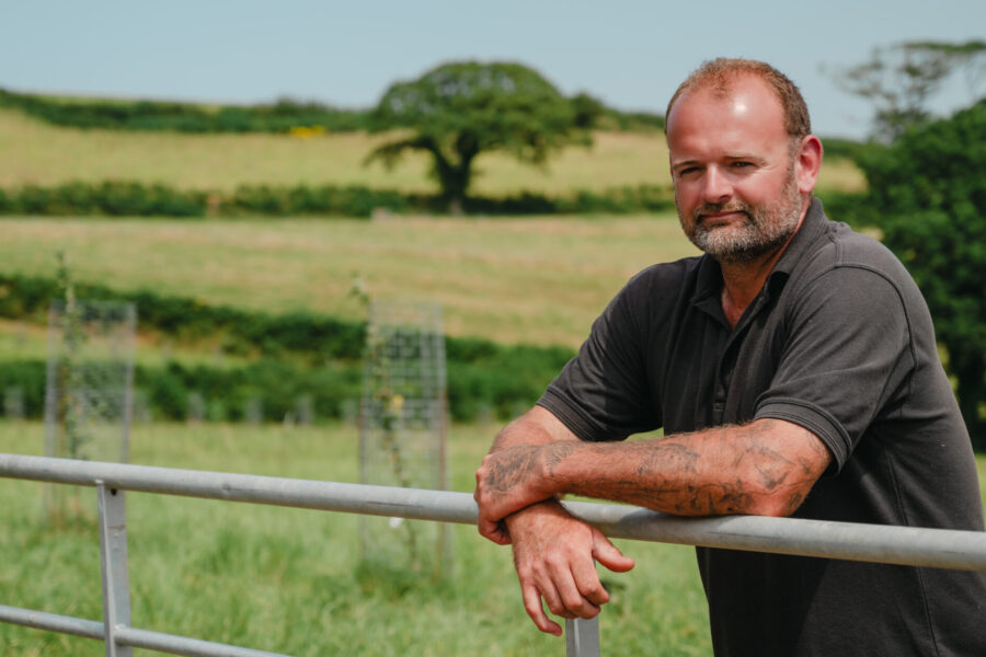 Farmer leaning on gate
